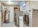 The laundry room includes a washer, dryer, utility sink, water heater, storage shelving, and window at 1622 Monroe St, Denver, CO 80206