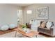 Bright living room with a sofa, wood coffee table, rug, and modern decor at 1622 Monroe St, Denver, CO 80206