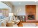 Cozy living room with a brick fireplace, hardwood floors, and comfortable seating arrangement at 1622 Monroe St, Denver, CO 80206