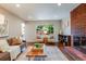 Bright living room featuring hardwood floors, a brick fireplace, and comfortable seating arrangement at 1622 Monroe St, Denver, CO 80206