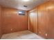 Wood paneled basement bedroom with window and closet at 1720 S Balsam St, Lakewood, CO 80232