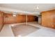 Unfinished basement with wood paneled walls and concrete floor at 1720 S Balsam St, Lakewood, CO 80232