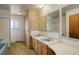 Retro bathroom featuring double sinks and a separate bathtub/shower at 1720 S Balsam St, Lakewood, CO 80232