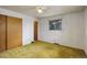The bedroom features closet space, natural light and wall-to-wall carpeting at 1720 S Balsam St, Lakewood, CO 80232