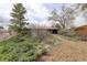 Quaint home surrounded by lush greenery and mature trees at 1720 S Balsam St, Lakewood, CO 80232