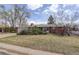 Charming one-story brick home featuring a well-maintained lawn and mature trees in a serene neighborhood at 1720 S Balsam St, Lakewood, CO 80232