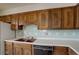 Features include wood cabinets, a double sink, white countertops and white and blue tile backsplash at 1720 S Balsam St, Lakewood, CO 80232