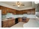 Functional kitchen with classic wooden cabinets, vintage stove and blue backsplash, ready for modern updates at 1720 S Balsam St, Lakewood, CO 80232