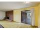 Inviting living room featuring a brick fireplace, with sliding glass door to a patio and cozy carpet at 1720 S Balsam St, Lakewood, CO 80232
