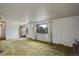 Bright living room with a wooden door, large window with curtains and cozy carpet at 1720 S Balsam St, Lakewood, CO 80232