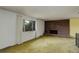 Bright living room featuring a brick fireplace, large window with curtains and cozy carpet at 1720 S Balsam St, Lakewood, CO 80232
