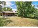 Spacious backyard with a covered patio and mature trees, ideal for outdoor living at 3900 Garland St, Wheat Ridge, CO 80033