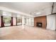 Spacious basement features a red brick fireplace and custom built-in shelving at 3900 Garland St, Wheat Ridge, CO 80033