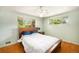 Serene bedroom features hardwood floors, a ceiling fan, and large windows offering abundant natural light and peaceful views at 3900 Garland St, Wheat Ridge, CO 80033