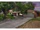 Charming brick ranch home with a well-manicured lawn and mature trees at 3900 Garland St, Wheat Ridge, CO 80033