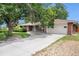 Charming brick ranch home with a well-manicured lawn and mature trees at 3900 Garland St, Wheat Ridge, CO 80033