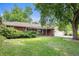 Well-maintained brick home with a lush green lawn and mature landscaping at 3900 Garland St, Wheat Ridge, CO 80033