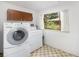 Practical laundry room with updated appliances, tiled floor, and natural light for an efficient chore space at 3900 Garland St, Wheat Ridge, CO 80033