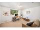 Bright living room with neutral tones, a large window, and comfortable seating, perfect for a relaxing workspace or lounge area at 3900 Garland St, Wheat Ridge, CO 80033