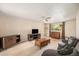 Cozy living room with carpet floors, a ceiling fan, and plenty of space for entertaining or relaxing with Gathering at 3900 Garland St, Wheat Ridge, CO 80033