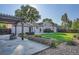 Backyard with a stone patio, pergola, grassy lawn, and mature trees at 4664 S Zang St, Morrison, CO 80465
