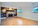 Basement area with brick fireplace and light hardwood style flooring at 4664 S Zang St, Morrison, CO 80465