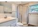 Bathroom featuring shower stall with frosted glass doors and a white vanity at 4664 S Zang St, Morrison, CO 80465