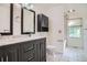 Modern bathroom featuring a sleek vanity with marble countertop and updated fixtures at 4664 S Zang St, Morrison, CO 80465