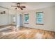 A bright bedroom is enhanced by light hardwood floors, natural light, and a mirrored closet at 4664 S Zang St, Morrison, CO 80465