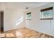 Bedroom with light hardwood floors and two large windows at 4664 S Zang St, Morrison, CO 80465