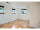 Bright bedroom with light hardwood floors and white paint at 4664 S Zang St, Morrison, CO 80465