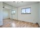Bedroom with hardwood floors, closet with sliding mirrored doors, and a window at 4664 S Zang St, Morrison, CO 80465