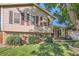 A tan two-story home with brown shutters and brick accents presents a cozy facade at 4664 S Zang St, Morrison, CO 80465