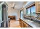 Kitchen featuring stainless steel appliances and wood cabinets with a pass through to a living area at 4664 S Zang St, Morrison, CO 80465