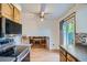Kitchen with stainless steel appliances and an adjacent living area with a fireplace at 4664 S Zang St, Morrison, CO 80465