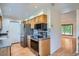 Kitchen featuring stainless steel appliances, wood cabinets, and granite countertops at 4664 S Zang St, Morrison, CO 80465