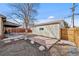 Backyard with stone patio, rock garden, and detached garage at 4499 E Colorado Ave, Denver, CO 80222