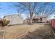Expansive backyard featuring a storage shed, mature tree, and a patio area for outdoor dining and entertainment at 4499 E Colorado Ave, Denver, CO 80222