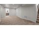 Finished basement featuring neutral carpeting and easy access to the stairs and utilities at 4499 E Colorado Ave, Denver, CO 80222