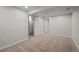 Basement area featuring a carpeted floor, neutral walls, and multiple doors at 4499 E Colorado Ave, Denver, CO 80222