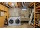 Unfinished basement featuring exposed ceiling, washer/dryer, and utility sink at 4499 E Colorado Ave, Denver, CO 80222