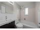Bright bathroom featuring a shower and tub, and a mirrored vanity at 4499 E Colorado Ave, Denver, CO 80222