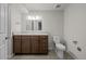 Neutral bathroom featuring a wooden vanity with countertop and a toilet at 4499 E Colorado Ave, Denver, CO 80222