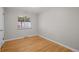 Cozy bedroom featuring neutral walls and bright hardwood flooring at 4499 E Colorado Ave, Denver, CO 80222