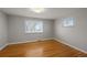 Bright bedroom features hardwood floors and plenty of natural light from two windows at 4499 E Colorado Ave, Denver, CO 80222