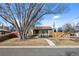 Charming ranch-style home with a large tree and a well-maintained front yard at 4499 E Colorado Ave, Denver, CO 80222