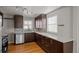 Modern kitchen with quartz countertops, stainless steel appliances, and dark brown cabinets at 4499 E Colorado Ave, Denver, CO 80222