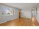 Cozy living room featuring hardwood floors, a large window, and neutral paint at 4499 E Colorado Ave, Denver, CO 80222