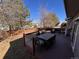 Back deck with a dining table and chairs plus outdoor grills and partial backyard view at 9889 Aftonwood St, Highlands Ranch, CO 80126