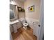 Cozy half bathroom with a pedestal sink, decorative mirror, and stylish wall decor at 9889 Aftonwood St, Highlands Ranch, CO 80126